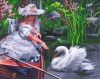Девочка кормит лебедя
